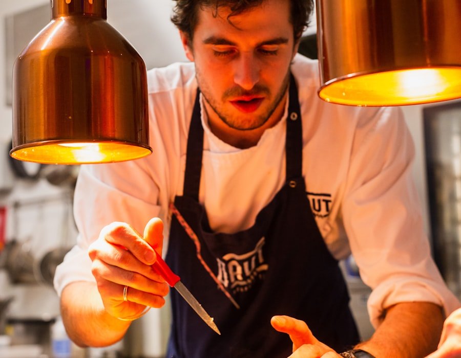 A chef mid-service under warm light, the best people recognised by name